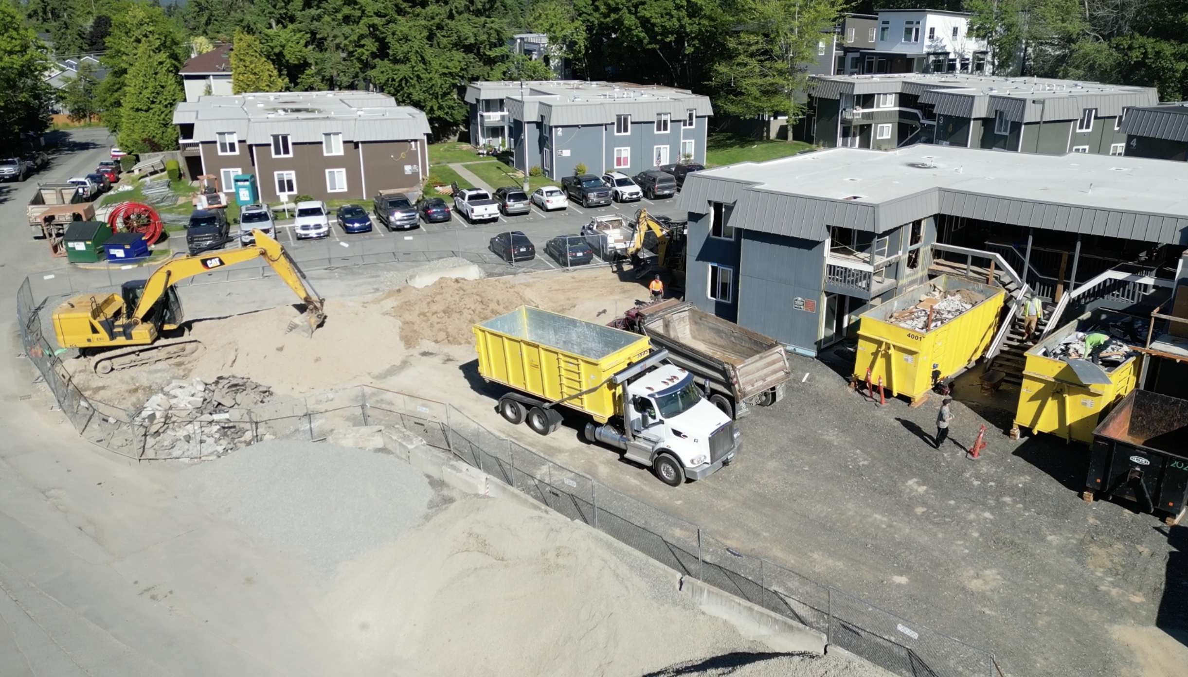 Driver delivering roll-off dumpster